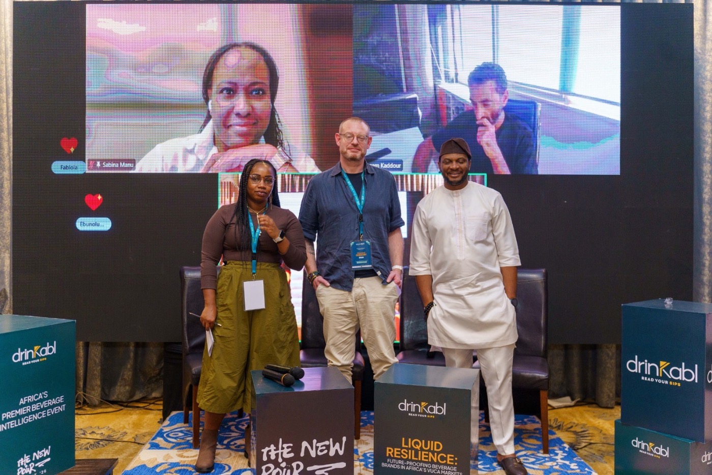 Panellists standing before the screen at the close of a session